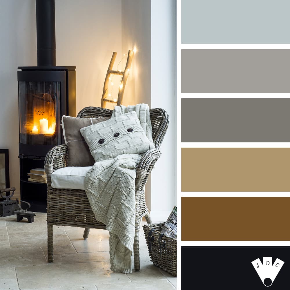 color palette à partir d'une photo d'intérieur avec un fauteuil gris avec coussins et plaid gris. Devant un poêle avec des bougies et une échelle en bois avec une guirlande électrique.